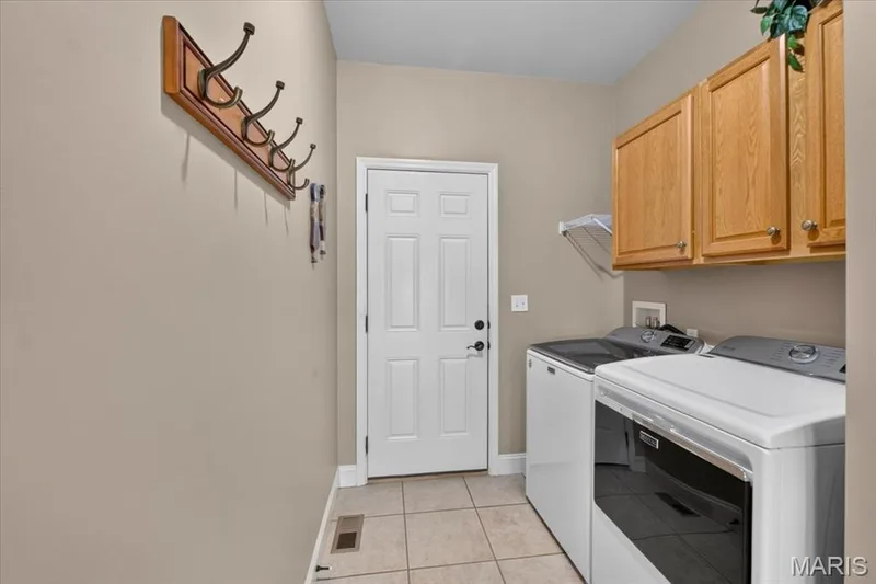 Main Level Laundry, entry to garage — 713 Bellingrath Gardens Court, Wentzville, MO 63385