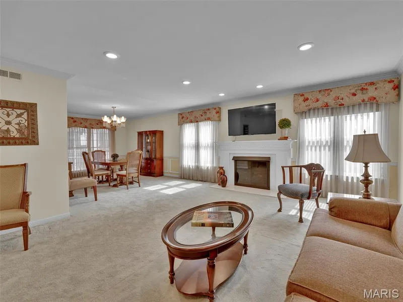Once at #206, enter into the spacious foyer and see an extremely spacious living room, with recessed lighting and a gas fireplace, and a dining room beyond. — 208 Ambridge Court #206, Chesterfield, MO 63017