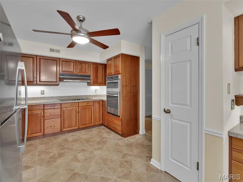 Another view of the kitchen, pantry and a small glimpse of the planning desk. — 208 Ambridge Court #206, Chesterfield, MO 63017