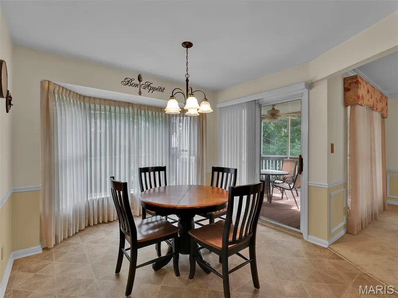 Roomy eat-in kitchen with the screen porch just beyond. — 208 Ambridge Court #206, Chesterfield, MO 63017