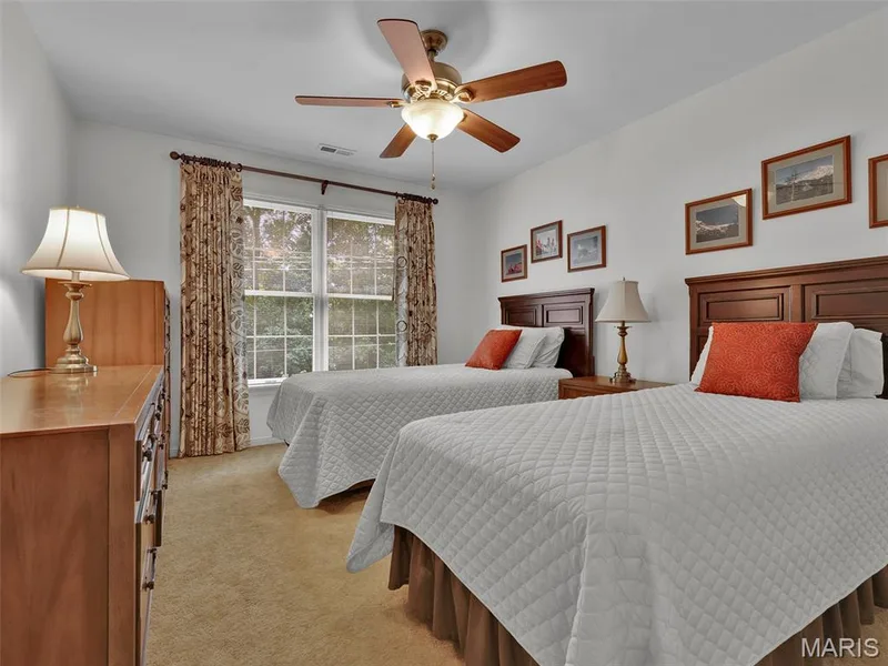 Bedroom 2 with large window and lighted ceiling fan. — 208 Ambridge Court #206, Chesterfield, MO 63017
