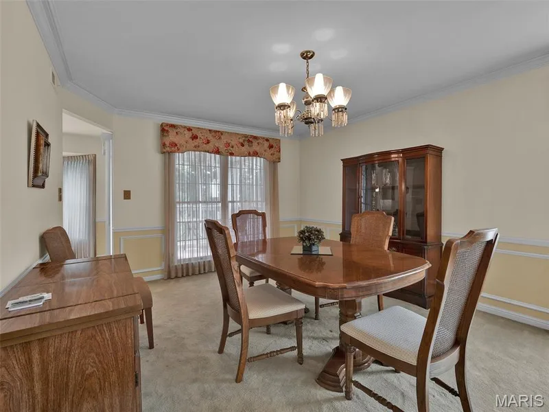 A view of the dining room with the screen porch beyond. — 208 Ambridge Court #206, Chesterfield, MO 63017