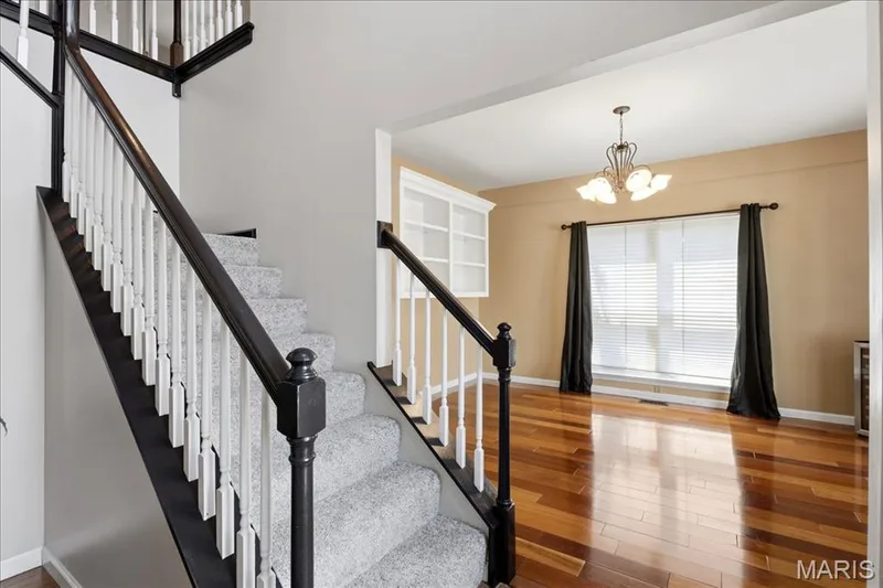 The 2-story foyer opens to the dining room with gleaming hardwood floor and built-ins. — 175 Beacon Point Lane, Wildwood, MO 63040