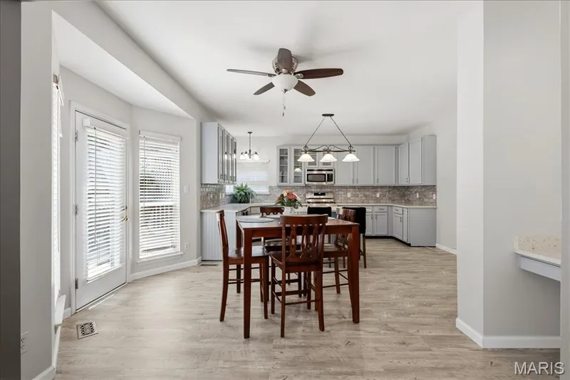 The breakfasts room has a planning desk in the corner and opens to the large deck. — 175 Beacon Point Lane, Wildwood, MO 63040