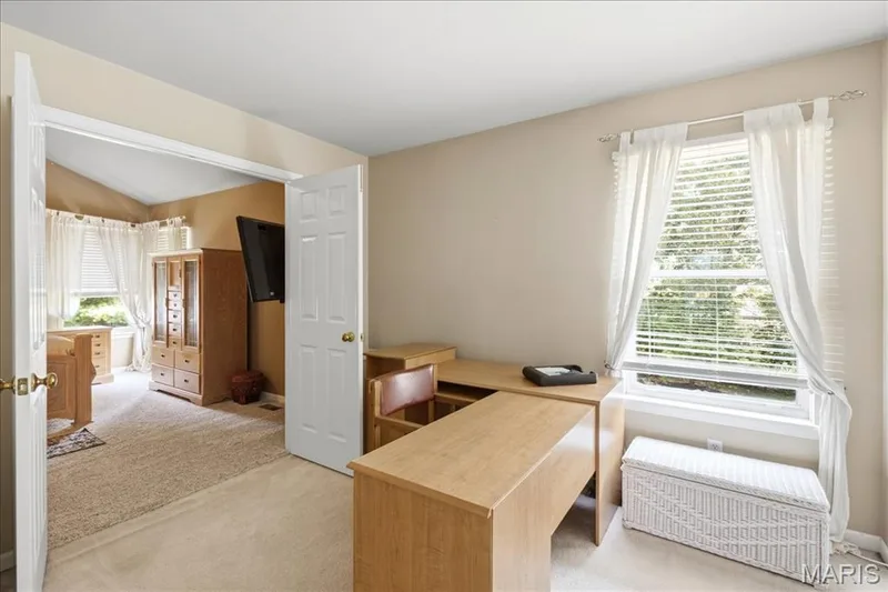 Second bedroom, with double closet, has French doors that open to the primary bedroom. — 175 Beacon Point Lane, Wildwood, MO 63040