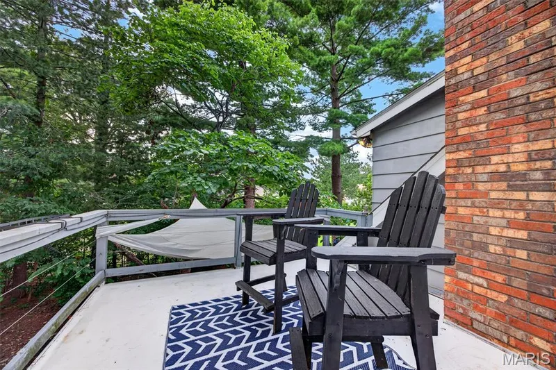 Exterior terrace balcony featuring a smooth surface, cable railing, and a partial brick facade — 4 Chantilly Court, Lake St. Louis, MO 63367