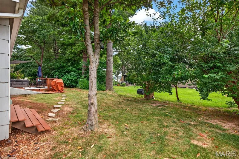Expansive green lawn framed by mature trees — 4 Chantilly Court, Lake St. Louis, MO 63367