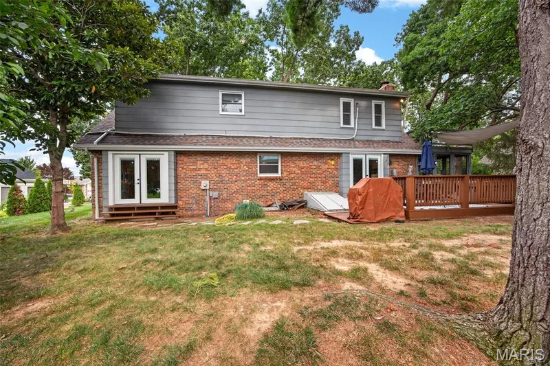Brick and siding exterior featuring multiple access points to the backyard — 4 Chantilly Court, Lake St. Louis, MO 63367