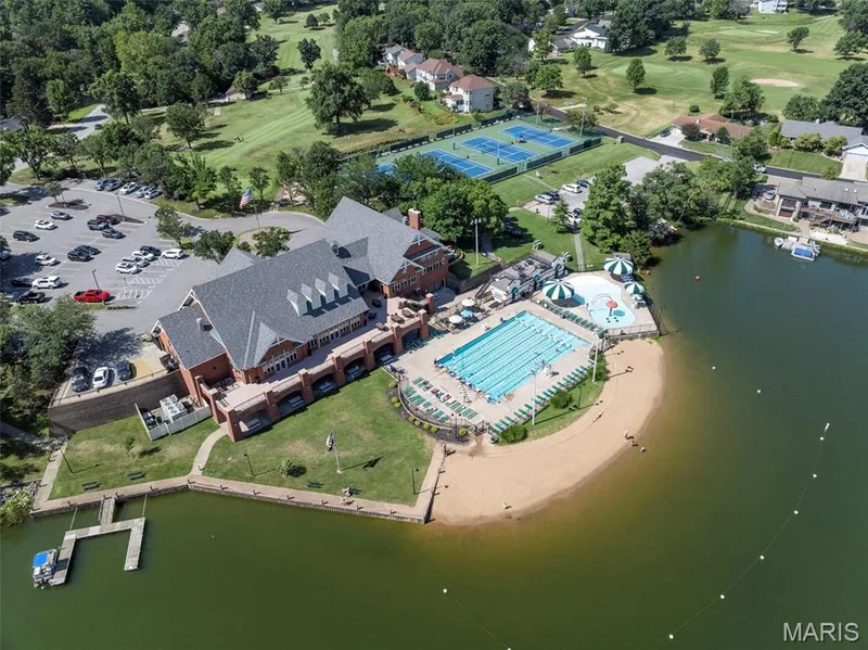 Expansive brick structure with a dark shingle roof situated on a waterfront property — 4 Chantilly Court, Lake St. Louis, MO 63367