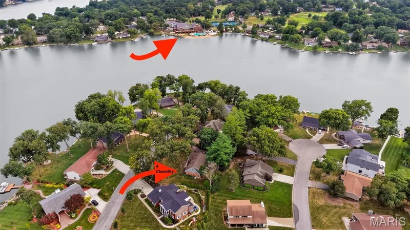 Aerial perspective showcasing a residential area with extensive waterfront access — 4 Chantilly Court, Lake St. Louis, MO 63367