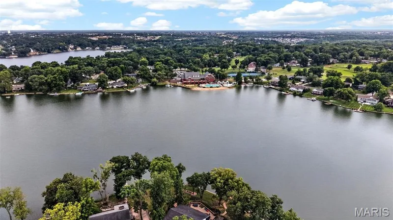 Expansive lakefront property with mature trees, green spaces, and a prominent shoreline — 4 Chantilly Court, Lake St. Louis, MO 63367
