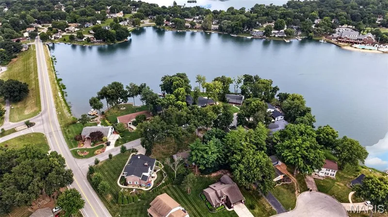 Waterfront property with mature trees, providing a natural setting — 4 Chantilly Court, Lake St. Louis, MO 63367