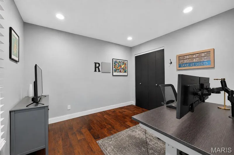 Main floor bedroom featuring wood-finish flooring, recessed lighting, and a neutral wall palette — 4 Chantilly Court, Lake St. Louis, MO 63367