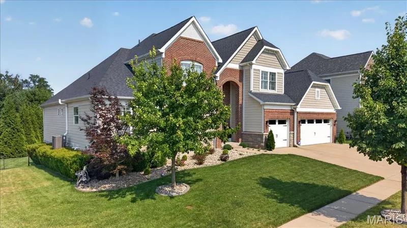 Stately brick and siding residence featuring a multi-gabled roofline — 302 Oak Stand Court, Chesterfield, MO 63005