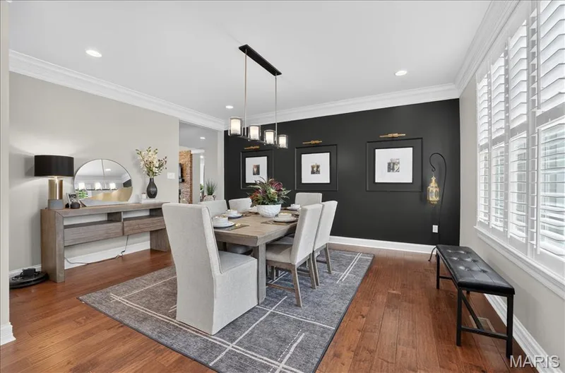Hardwood-style flooring extends throughout this space featuring crown molding and recessed lighting — 302 Oak Stand Court, Chesterfield, MO 63005