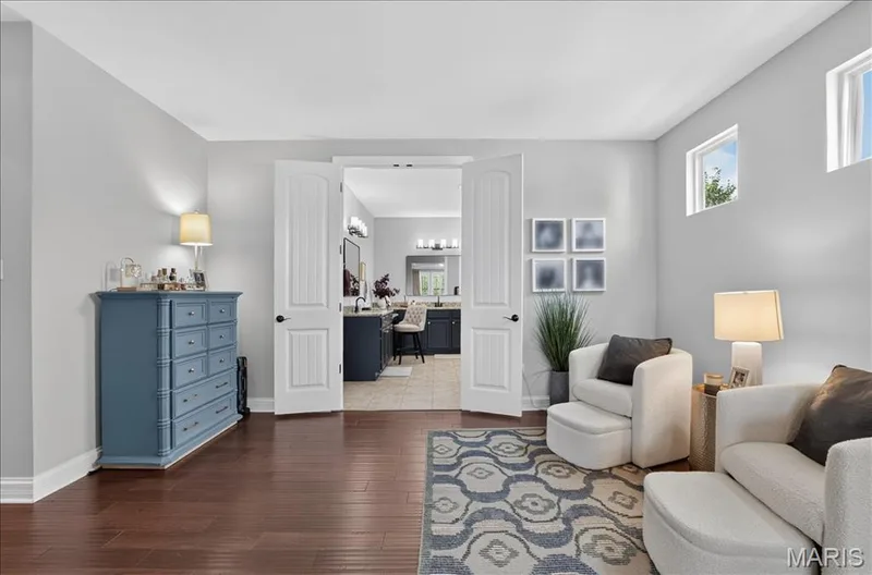 Spacious room featuring wood-finish flooring and light gray walls — 302 Oak Stand Court, Chesterfield, MO 63005