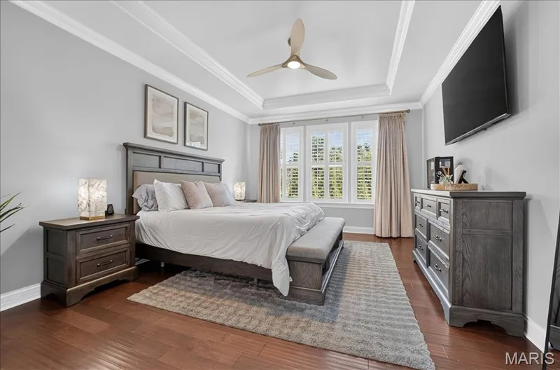 Recessed tray ceiling with crown molding, featuring a modern ceiling fan — 302 Oak Stand Court, Chesterfield, MO 63005