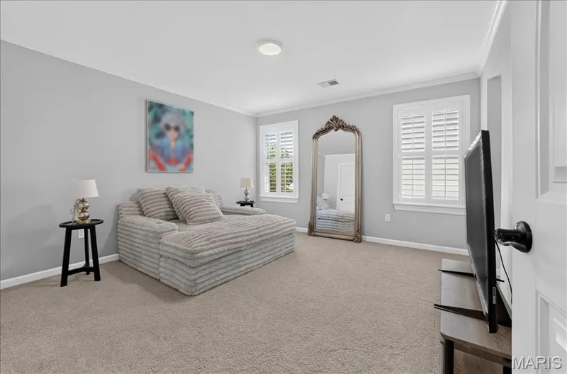 Carpeted room featuring light gray walls, white crown molding, and two windows with white plantation shutters — 302 Oak Stand Court, Chesterfield, MO 63005