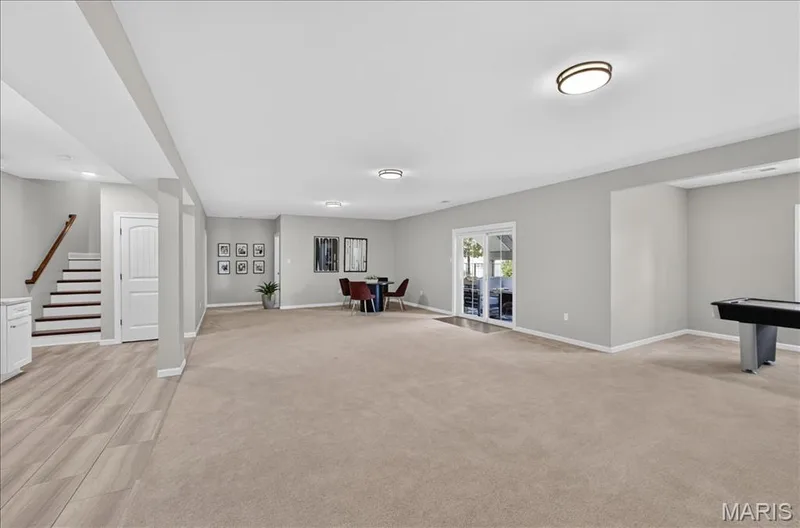 Spacious lower-level area with neutral carpeting and light gray walls — 302 Oak Stand Court, Chesterfield, MO 63005