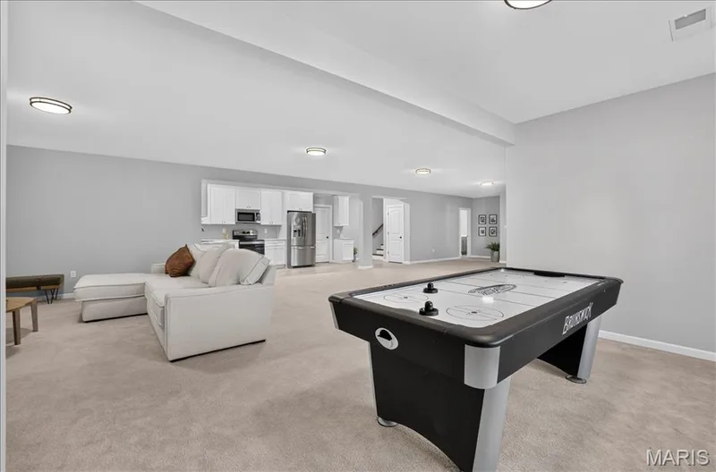 Spacious recreation area featuring recessed lighting, light-toned carpeting, and light gray walls — 302 Oak Stand Court, Chesterfield, MO 63005