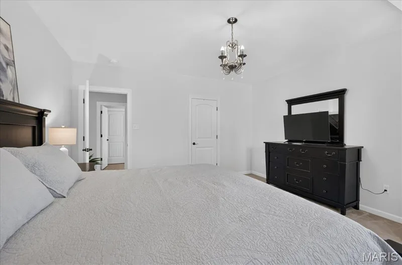 Spacious room featuring light gray wall paint and light-colored carpeting — 302 Oak Stand Court, Chesterfield, MO 63005