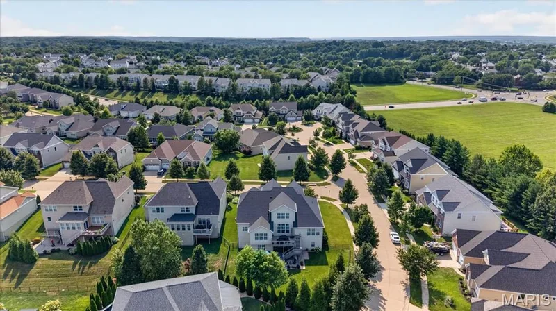 Established residential area featuring detached homes with varied architectural styles, mature landscaping, and paved streets — 302 Oak Stand Court, Chesterfield, MO 63005