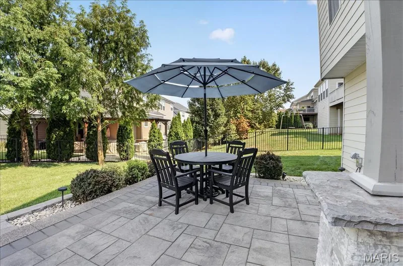 Stone paver patio featuring a built-in stone accent wall — 302 Oak Stand Court, Chesterfield, MO 63005