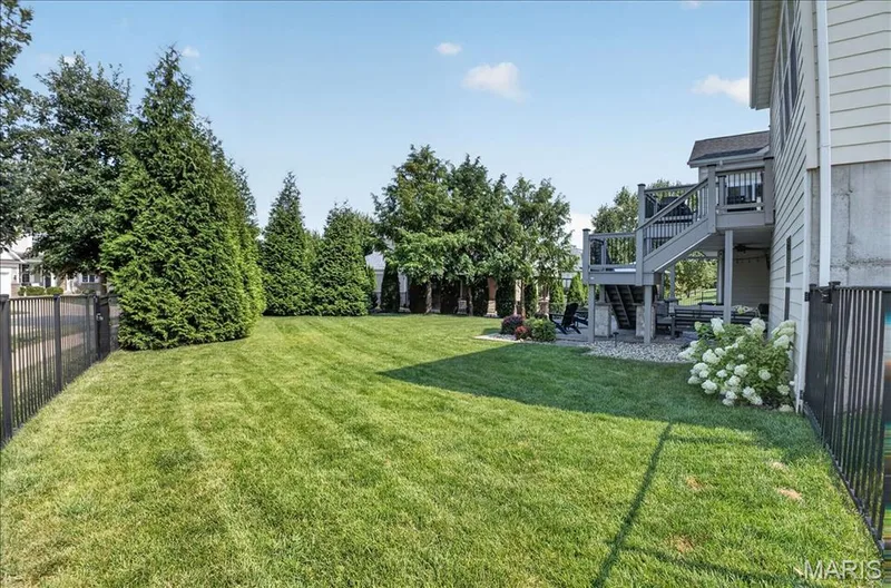 Expansive green lawn framed by mature evergreen trees — 302 Oak Stand Court, Chesterfield, MO 63005
