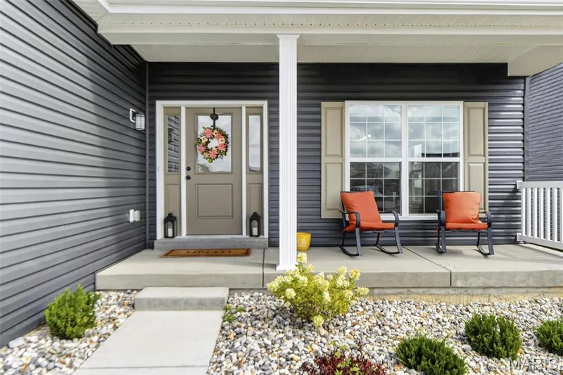 Front exterior view. Enjoy downtime sitting out on this front porch! — 403 Yellow Rose Court, Wentzville, MO 63385