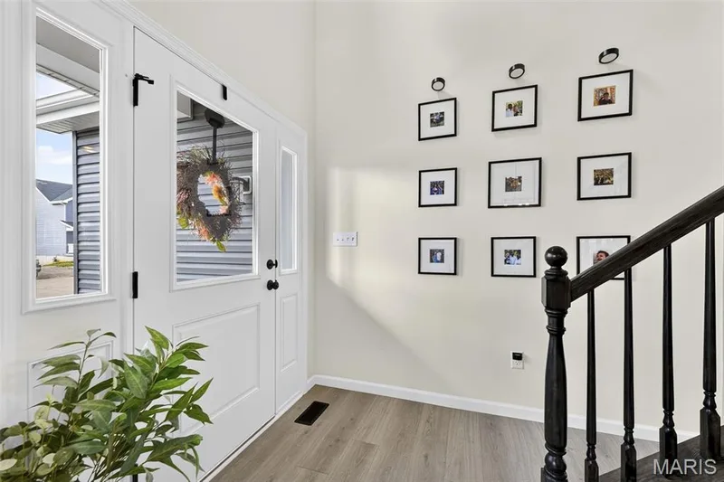Beautiful two-story entry with an open railing leading to the upper floor. — 403 Yellow Rose Court, Wentzville, MO 63385