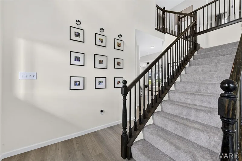 Beautiful two-story entry with an open railing leading to the upper floor. — 403 Yellow Rose Court, Wentzville, MO 63385
