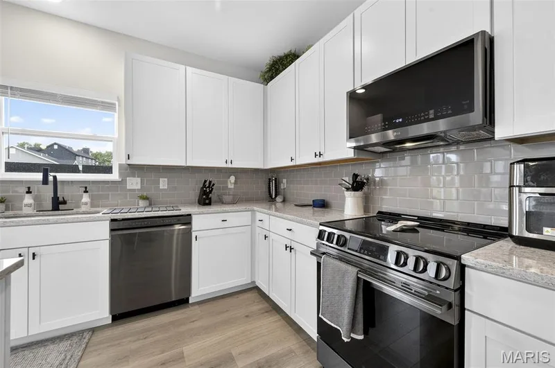 Soak in this spacious and exquisitely designed kitchen! Nice and cozy to enjoy a quiet cup of coffee in the morning. Never miss a moment during entertaining with the open concept between the kitchen and living room! — 403 Yellow Rose Court, Wentzville, MO 63385