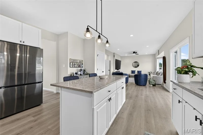Soak in this spacious and exquisitely designed kitchen! Nice and cozy to enjoy a quiet cup of coffee in the morning. Never miss a moment during entertaining with the open concept between the kitchen and living room! — 403 Yellow Rose Court, Wentzville, MO 63385