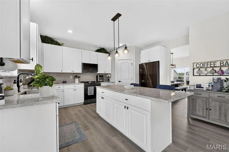 Soak in this spacious and exquisitely designed kitchen! Nice and cozy to enjoy a quiet cup of coffee in the morning. Never miss a moment during entertaining with the open concept between the kitchen and living room! — 403 Yellow Rose Court, Wentzville, MO 63385