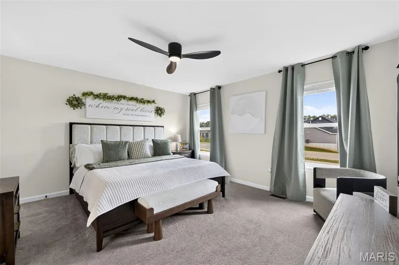 Spacious primary bedroom on the upper level, complete with ensuite bath and walk-in closet. — 403 Yellow Rose Court, Wentzville, MO 63385