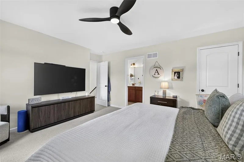 Spacious primary bedroom on the upper level, complete with ensuite bath and walk-in closet. — 403 Yellow Rose Court, Wentzville, MO 63385