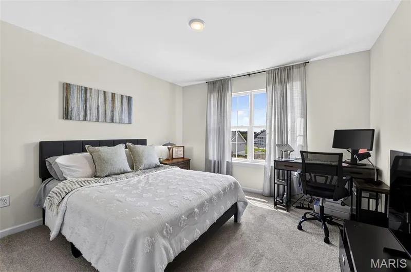 Bedroom 2 located on the upper floor and toward the front of the home, featuring a double window view and lots of natural light! — 403 Yellow Rose Court, Wentzville, MO 63385