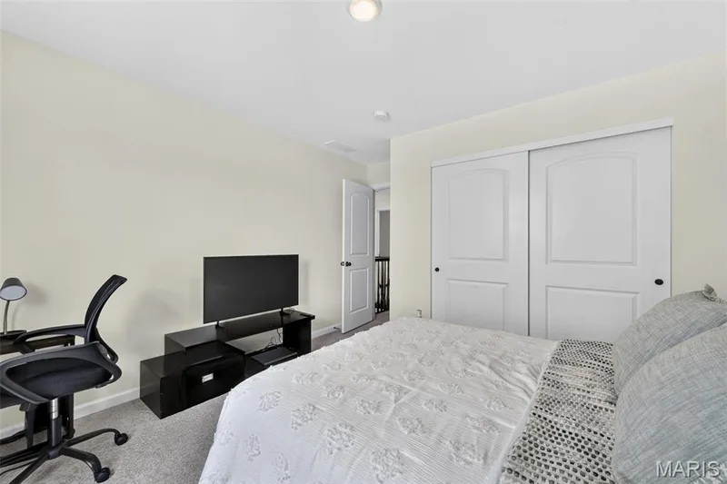 Bedroom 2 located on the upper floor and toward the front of the home, featuring a double window view and lots of natural light! — 403 Yellow Rose Court, Wentzville, MO 63385