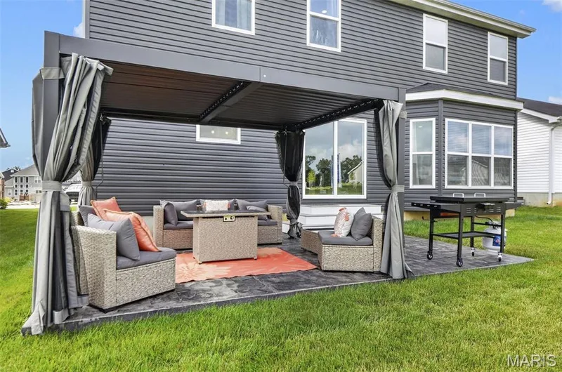 Enjoy relaxing days out on the stamped concrete patio, under the shade of the pergola! — 403 Yellow Rose Court, Wentzville, MO 63385