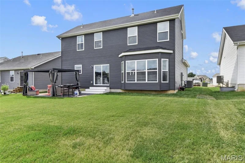 Spend time enjoying the outdoors and utilizing the spacious, flat, and open back yard for many different types of entertaining and activities. — 403 Yellow Rose Court, Wentzville, MO 63385