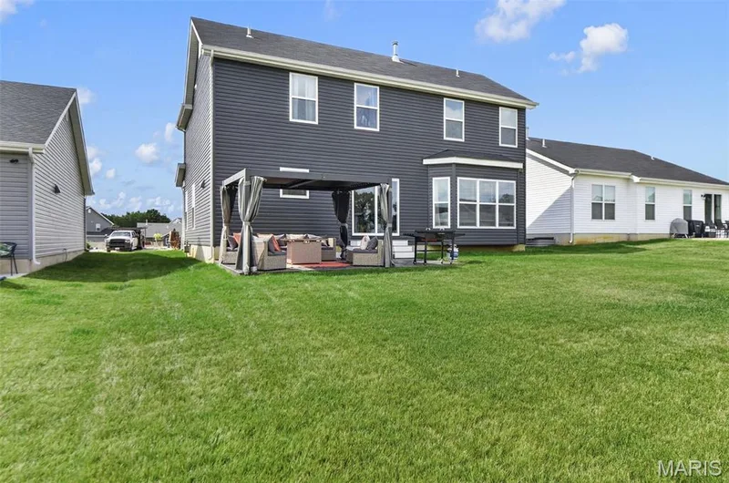 Spend time enjoying the outdoors and utilizing the spacious, flat, and open back yard for many different types of entertaining and activities. — 403 Yellow Rose Court, Wentzville, MO 63385