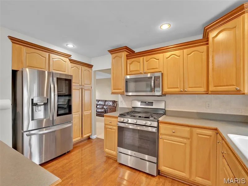 Kitchen with stainless steel appliances and loads of cabinetry. — 34 Shadow Creek Drive, St Peters, MO 63376