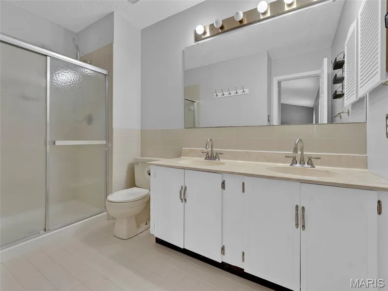 Primary bathroom with double sinks and walk in shower. — 34 Shadow Creek Drive, St Peters, MO 63376