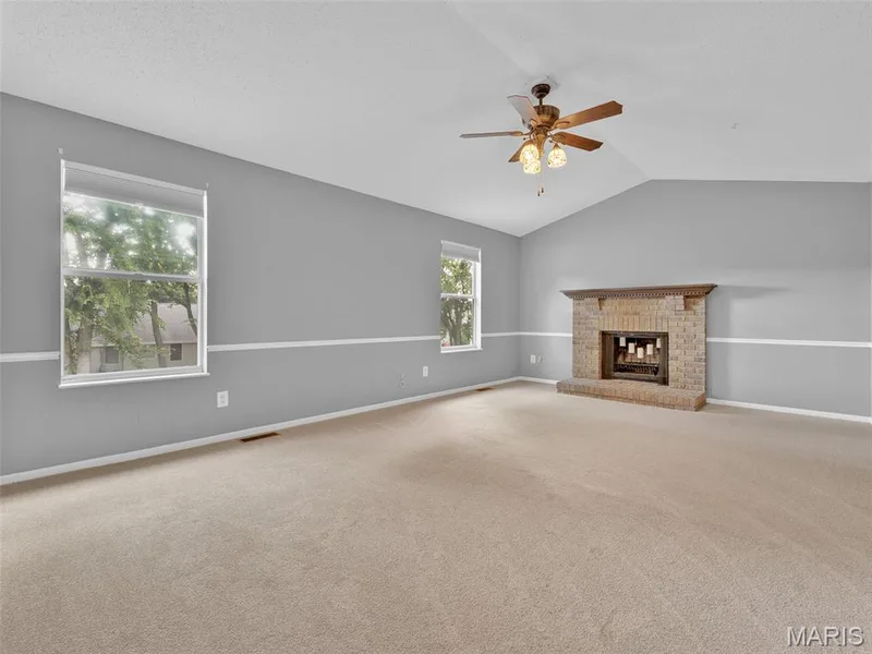 Huge primary bedroom with fireplace, vaulted ceiling lighted ceiling fan, and brand new carpet. — 34 Shadow Creek Drive, St Peters, MO 63376