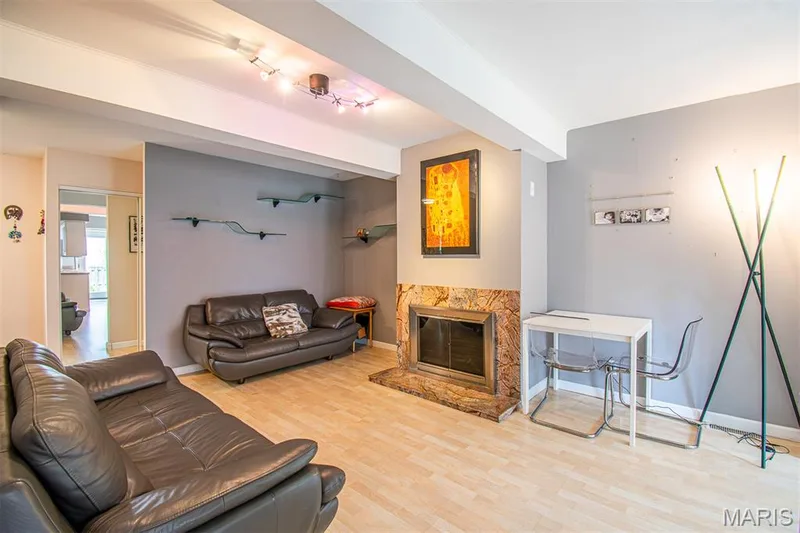 FAMILY ROOM –  With Fireplace - Opens to Kitchen with Breakfast Area & exit to the fenced backyard. Living area featuring light wood-finish flooring, a fireplace with a stone surround, recessed ceiling lighting, and decorative wall shelving — 13261 COCHERO Drive, Chesterfield, MO 63141