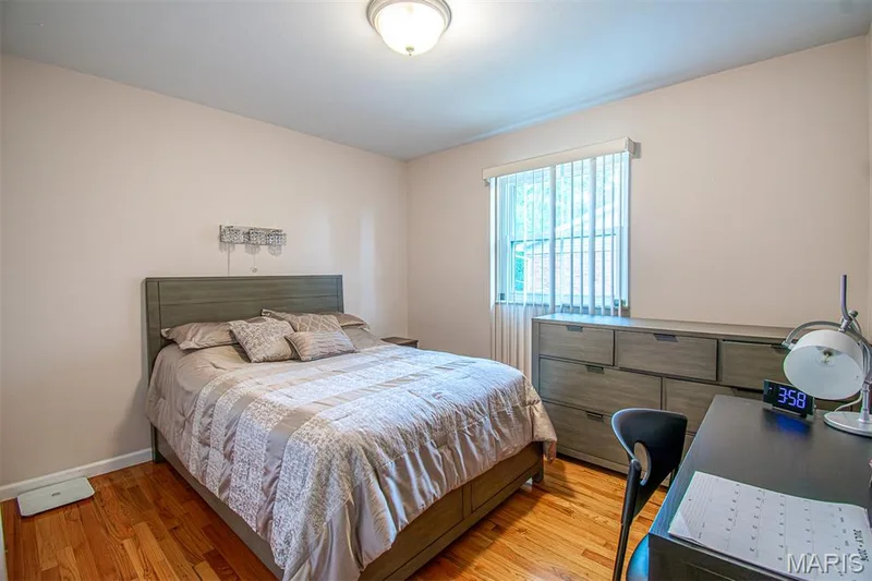 BEDROOM # 2 – With Double Closets & featuring wood-finish flooring, a contemporary ceiling light fixture, a window with vertical blinds, and neutral wall tone — 13261 COCHERO Drive, Chesterfield, MO 63141