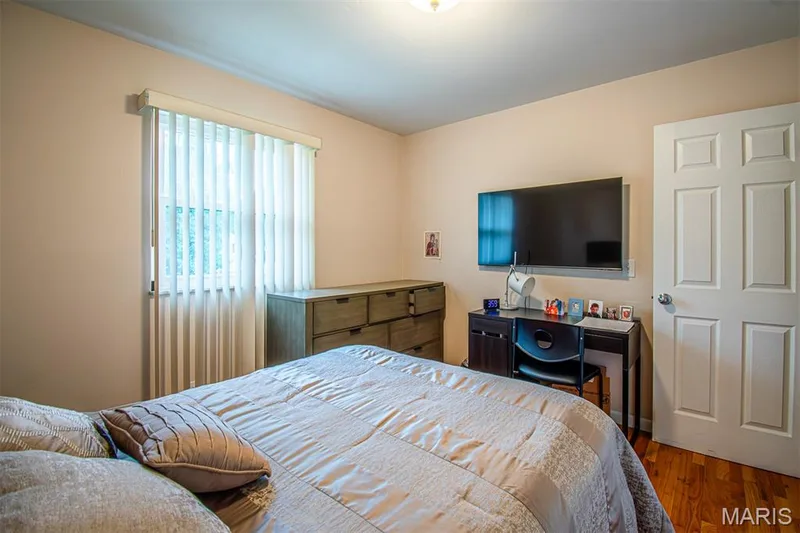 BEDROOM # 2 – With Double Closets & featuring wood-finish flooring, a contemporary ceiling light fixture, a window with vertical blinds, and neutral wall tone and a six-panel door — 13261 COCHERO Drive, Chesterfield, MO 63141