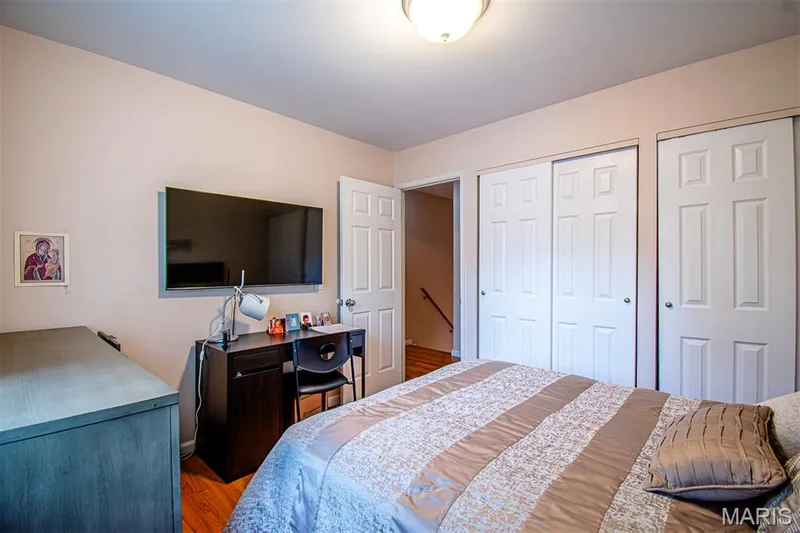 BEDROOM # 2 - featuring wood-finish flooring, a flush-mount ceiling light fixture, and two sets of bi-fold closet doors — 13261 COCHERO Drive, Chesterfield, MO 63141