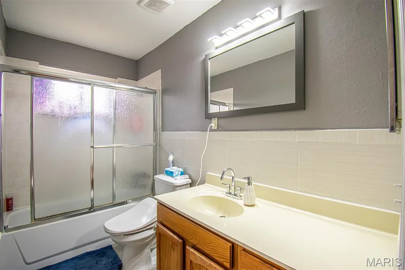 GUEST BATHROOM - Featuring a tub/shower combination with sliding frosted glass doors — 13261 COCHERO Drive, Chesterfield, MO 63141