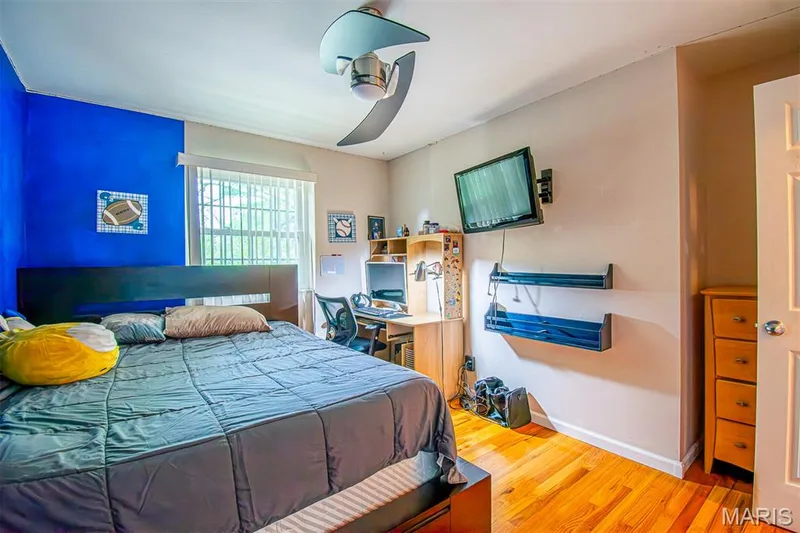 BEDROOM # 3 – With Walk-in closet & a niche for Dresser  - featuring wood-finish flooring, a ceiling fan with integrated lighting, and a window with blinds — 13261 COCHERO Drive, Chesterfield, MO 63141